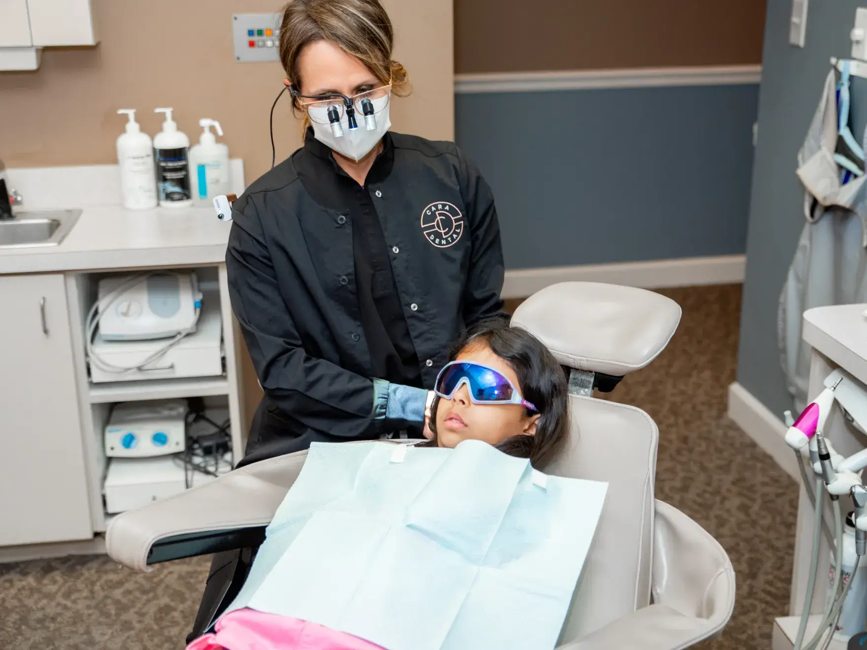Dentist with child in dental chair