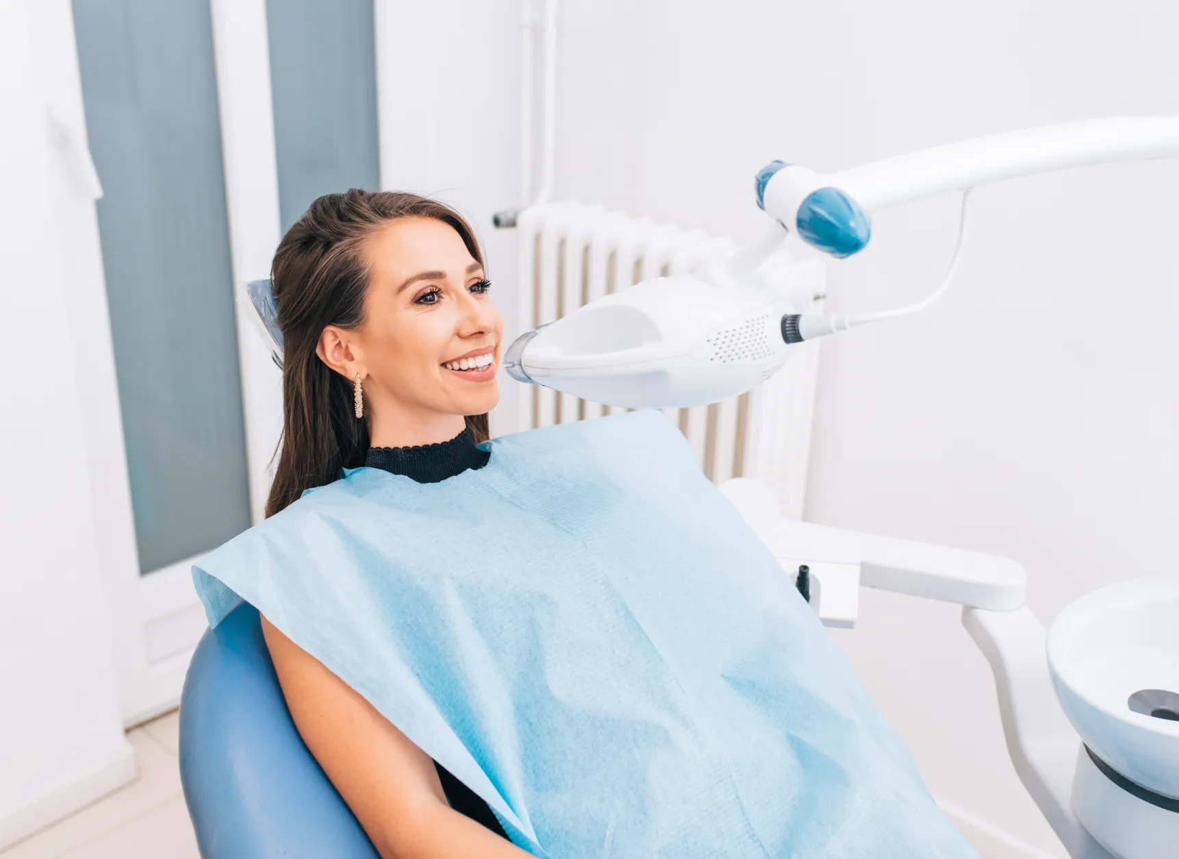 Patient smiling during whitening of teeth