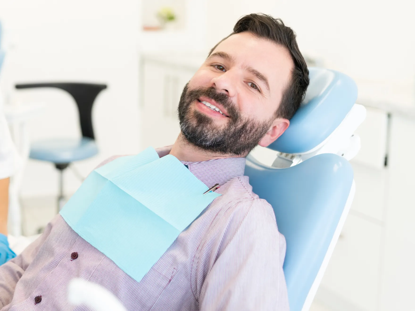 Patient in dental chair smiling