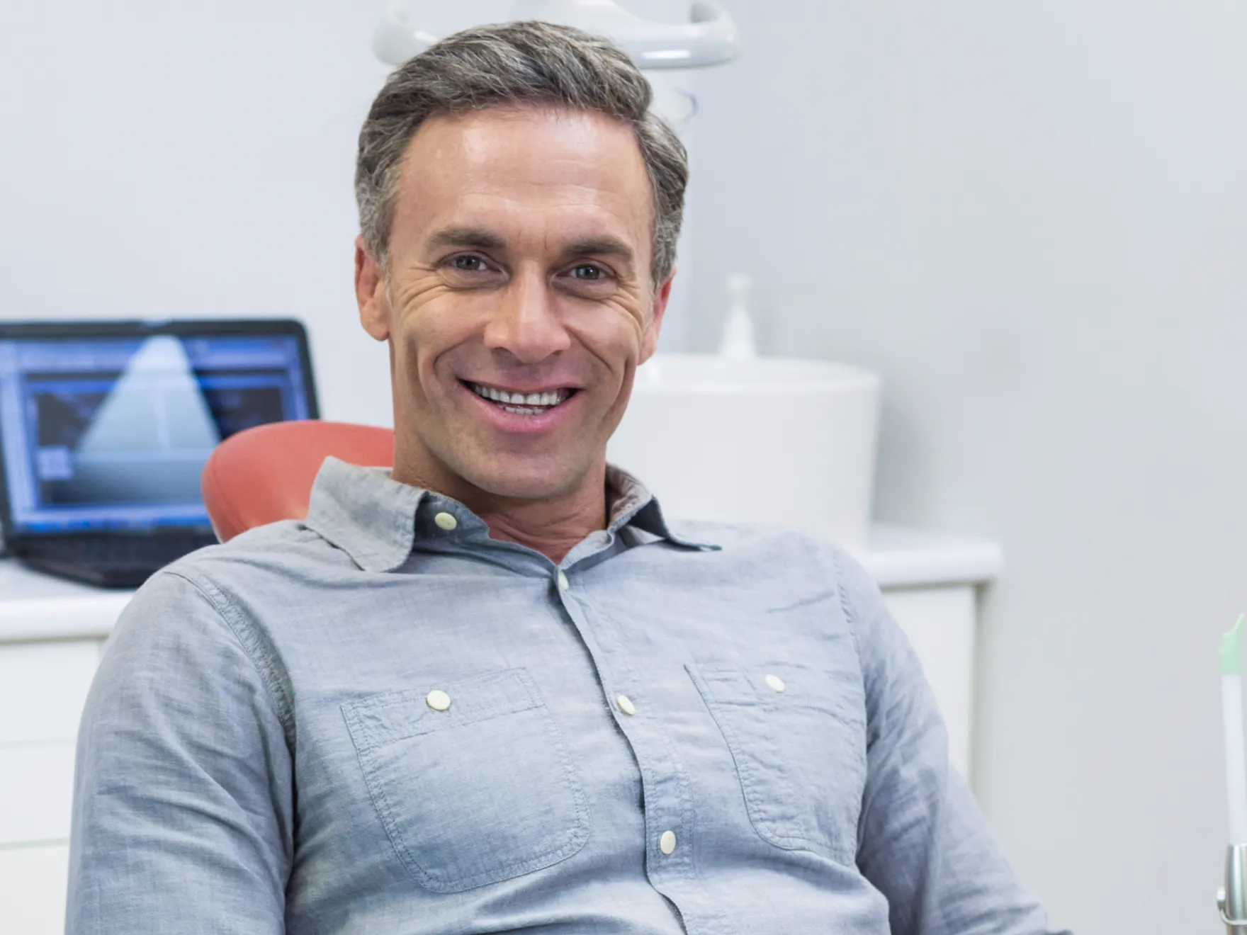 Patient in dental chair smiling