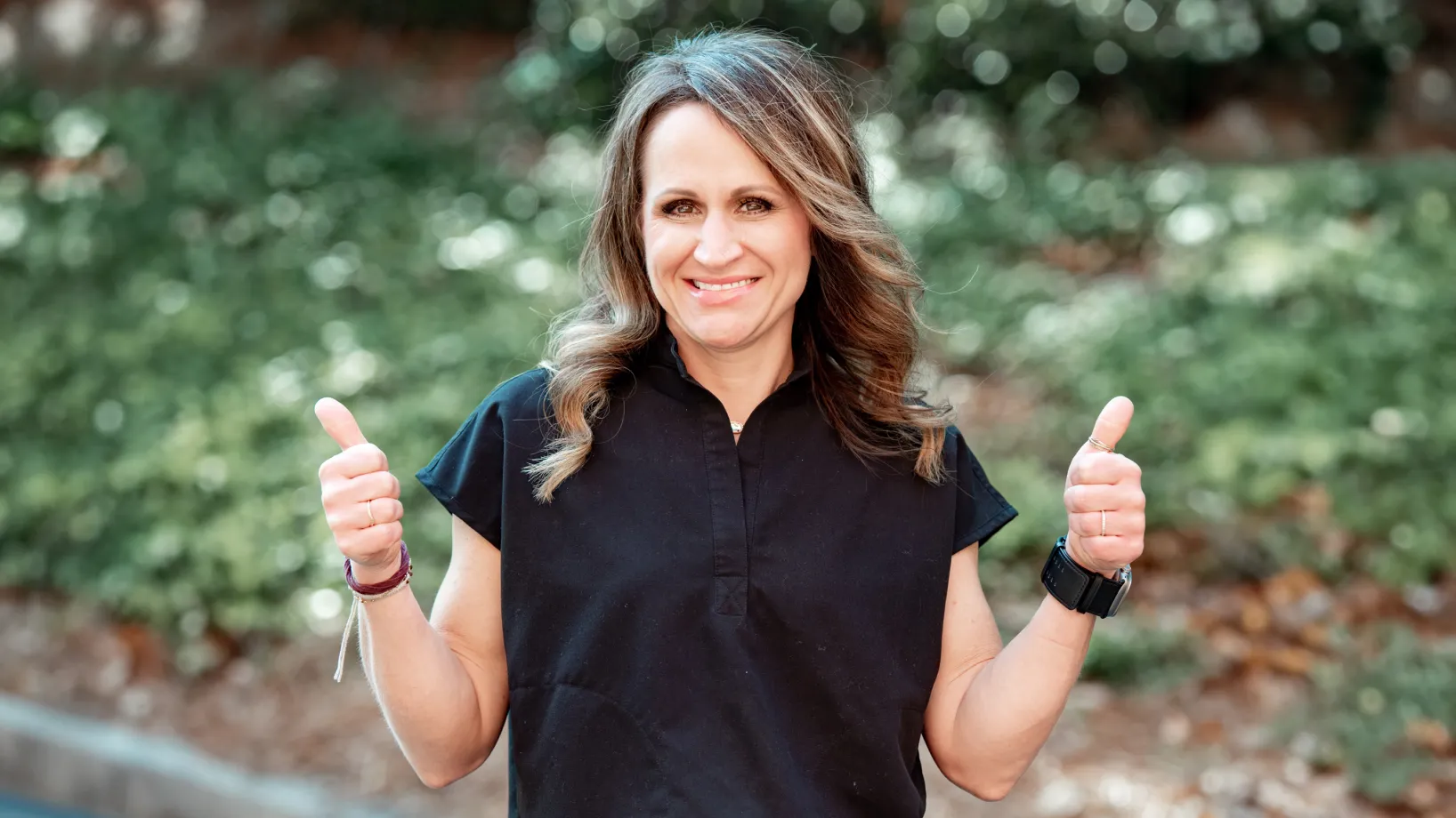 Team member doing a thumbs up and smiling