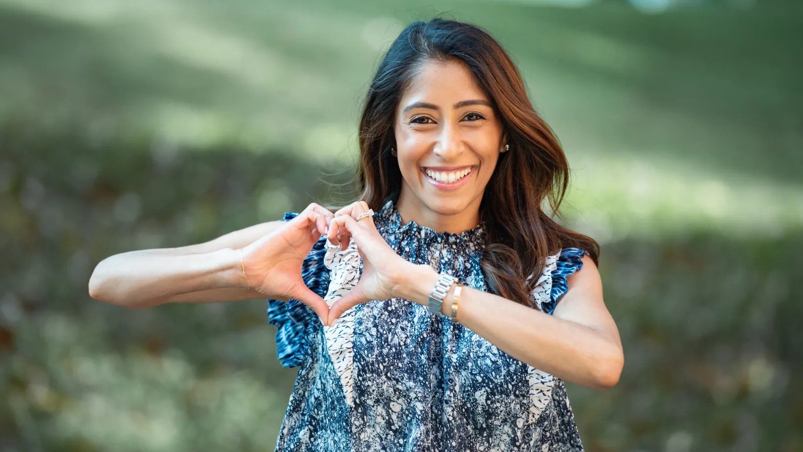 Dr. Cara making a heart with her hands