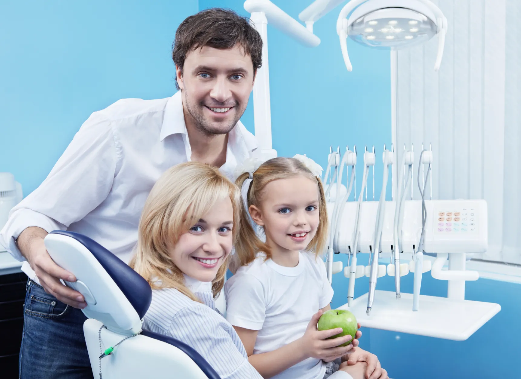 Family in dental office smiling