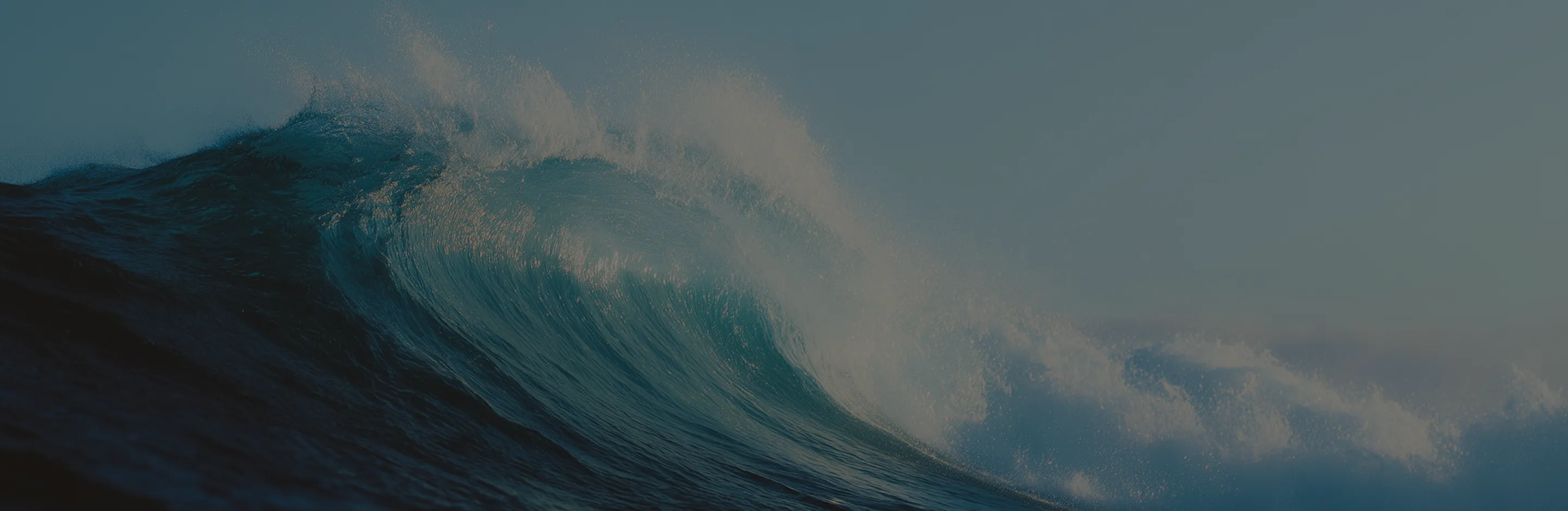 A large wave in the middle of the ocean.
