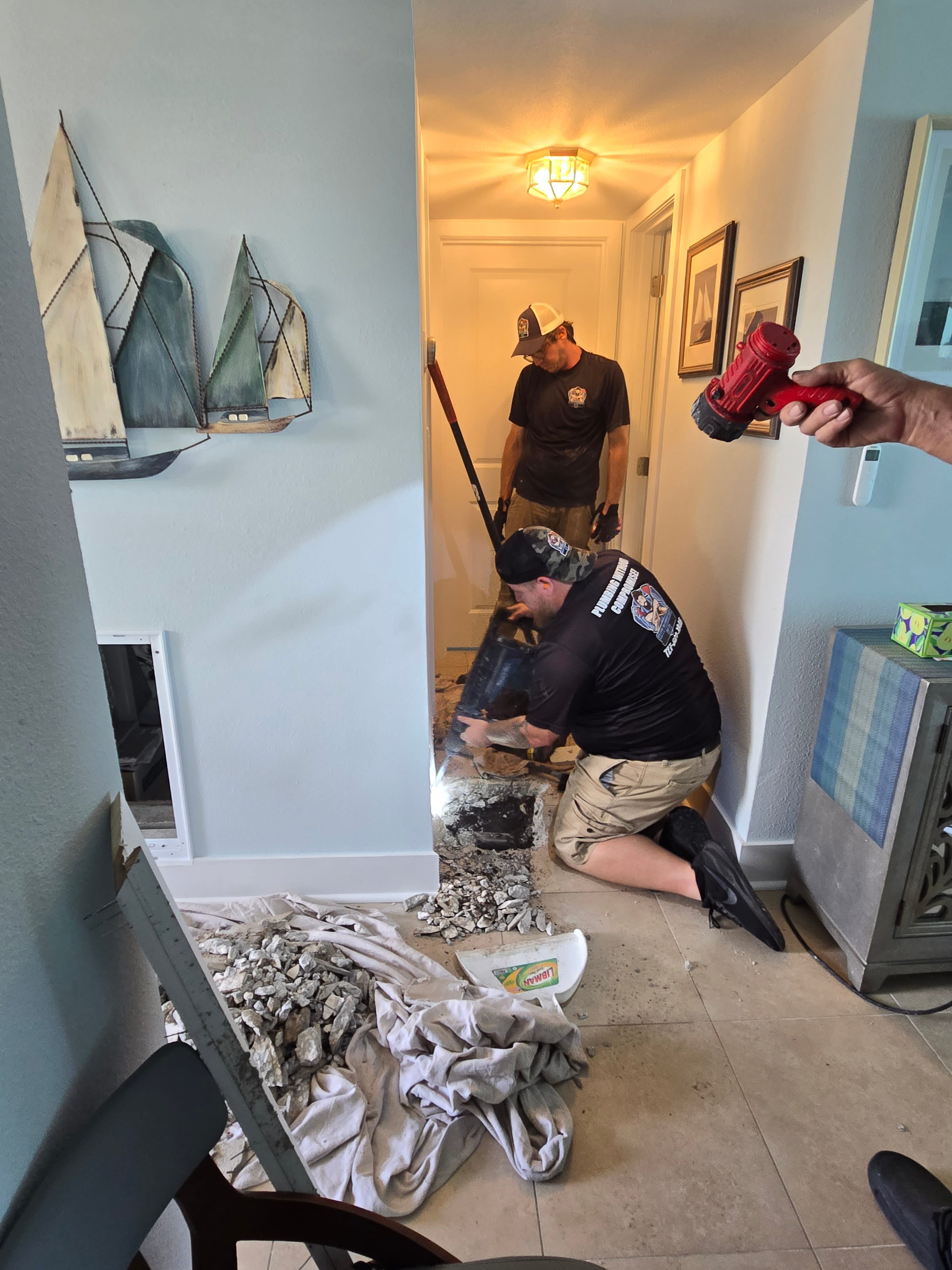 plumbers servicing pipes
