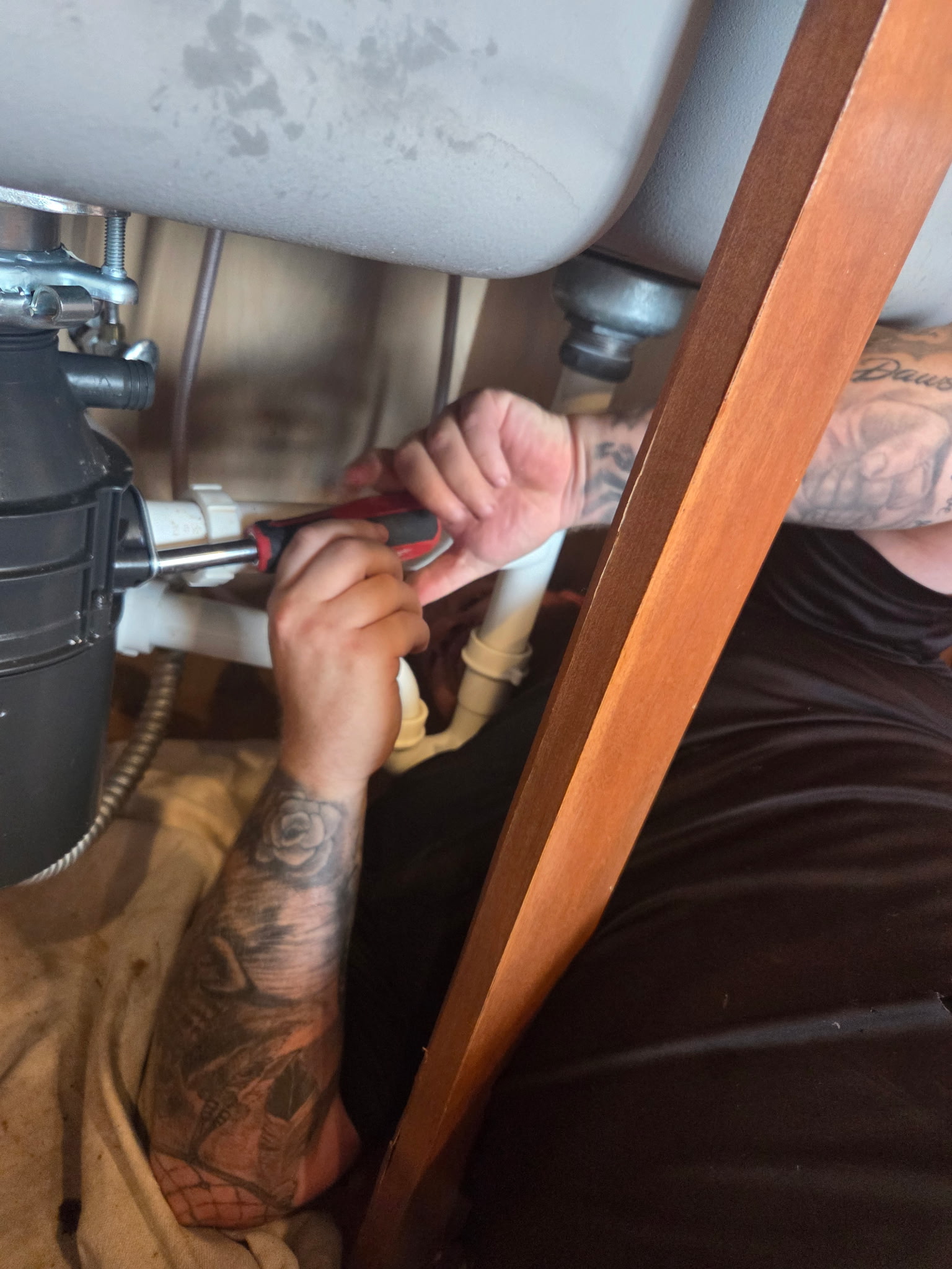 plumber doing maintenance on a sink