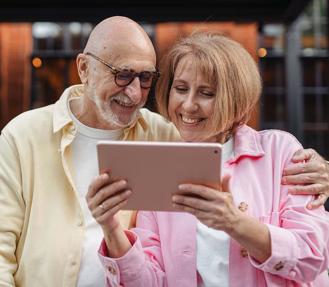Smiling senior couple booking a health screening