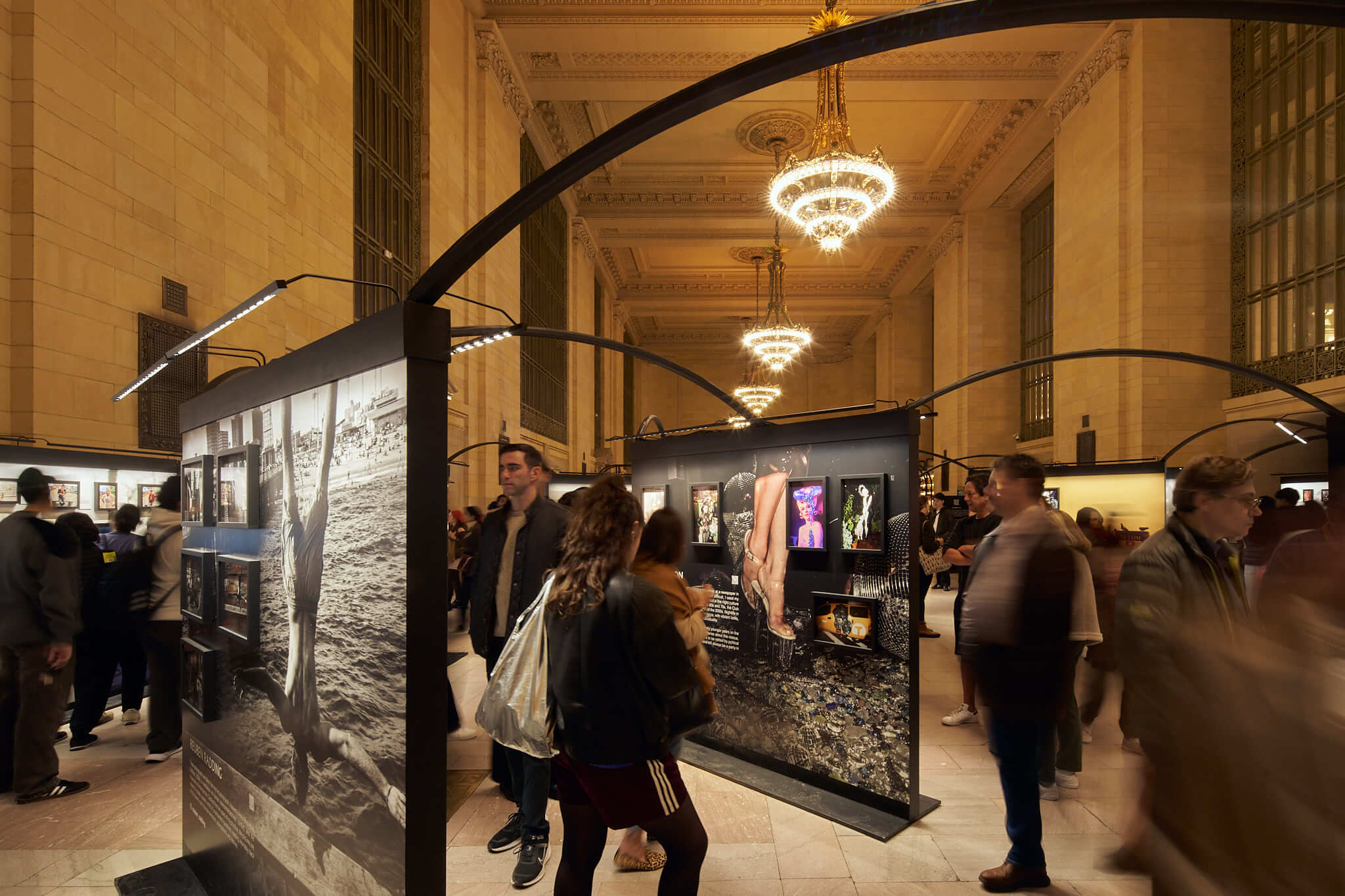 People looking at the exhibit in Vanderbilt Hall, Grand Central during Dear New York, an art installation. 