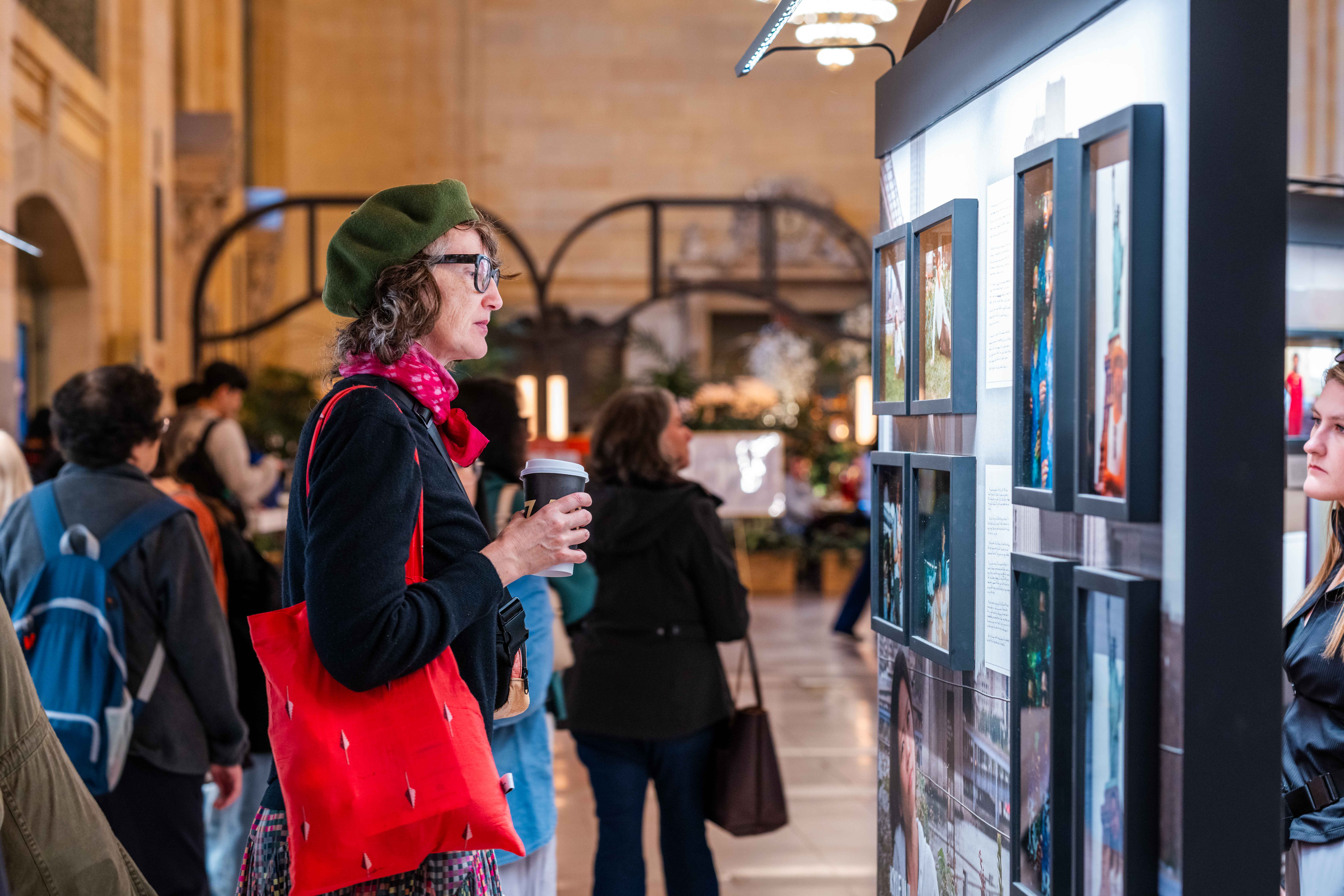 A woman looking at the exhibit in Vanderbilt Hall, Grand Central during Dear New York, an art installation. 