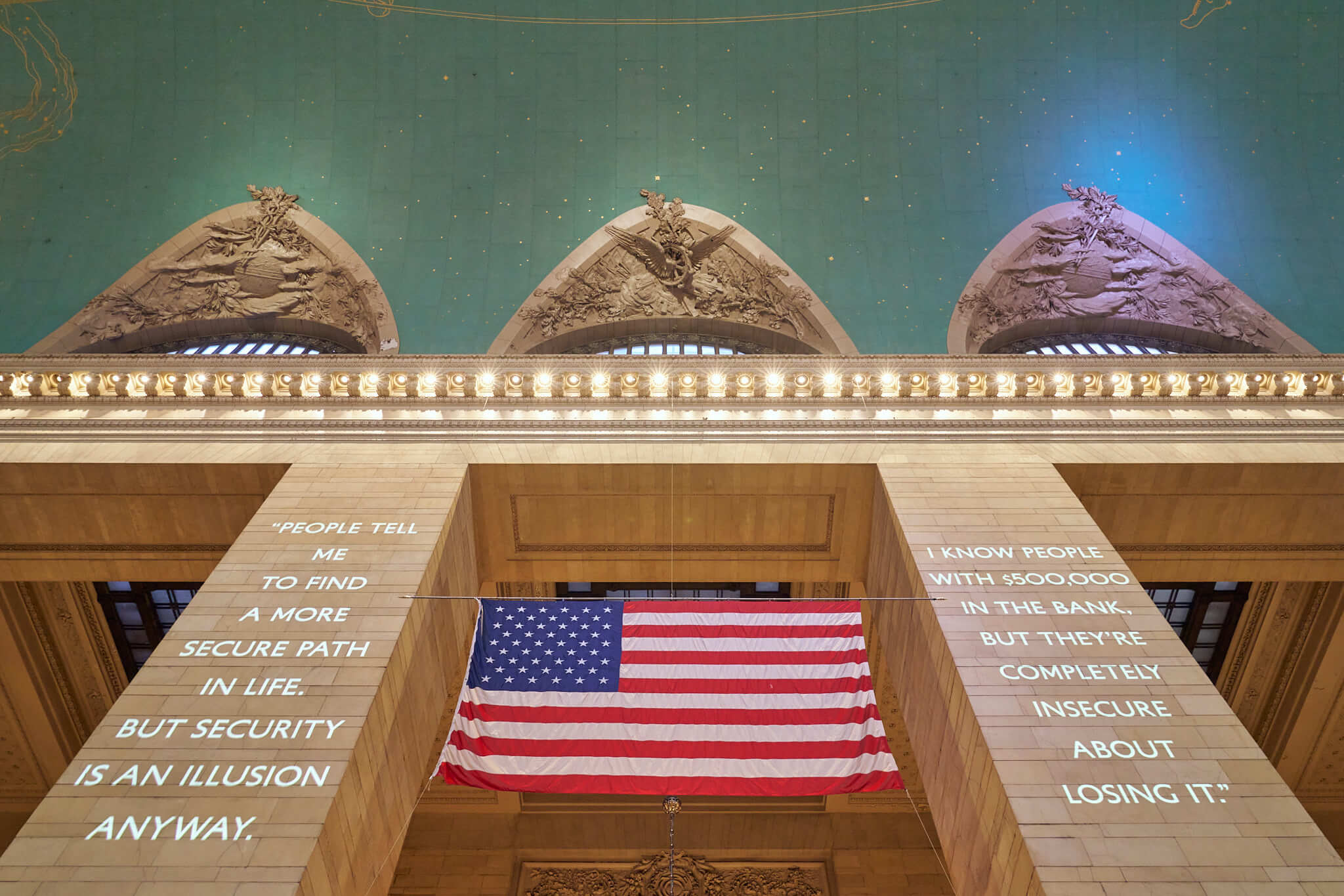 A close up of the columns in the Main Concourse at Grand Central. Showing the large projections during Dear New York, an art installation.