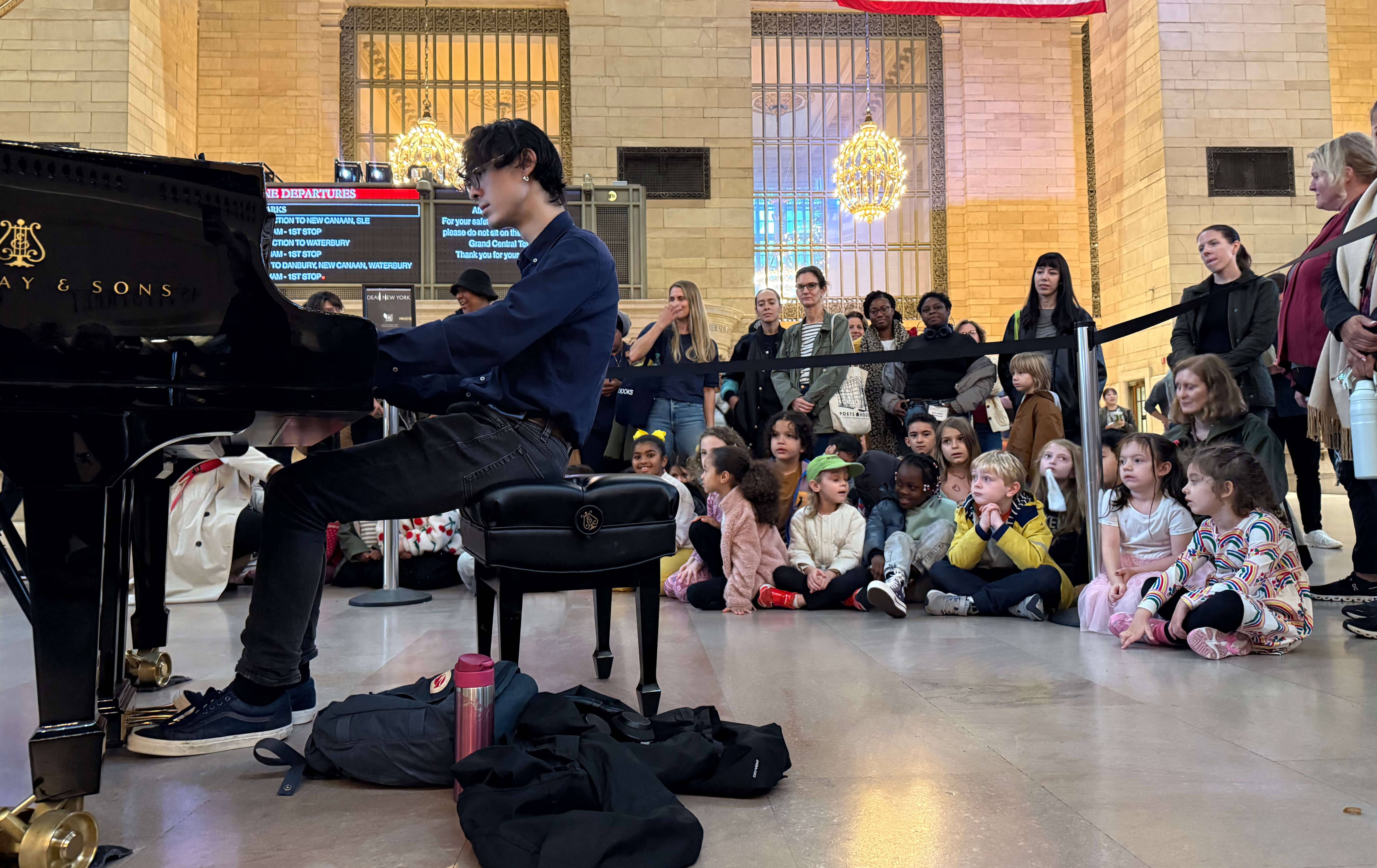 A man playing the Steinway piano at during Dear New York an art installation at Grand Central 