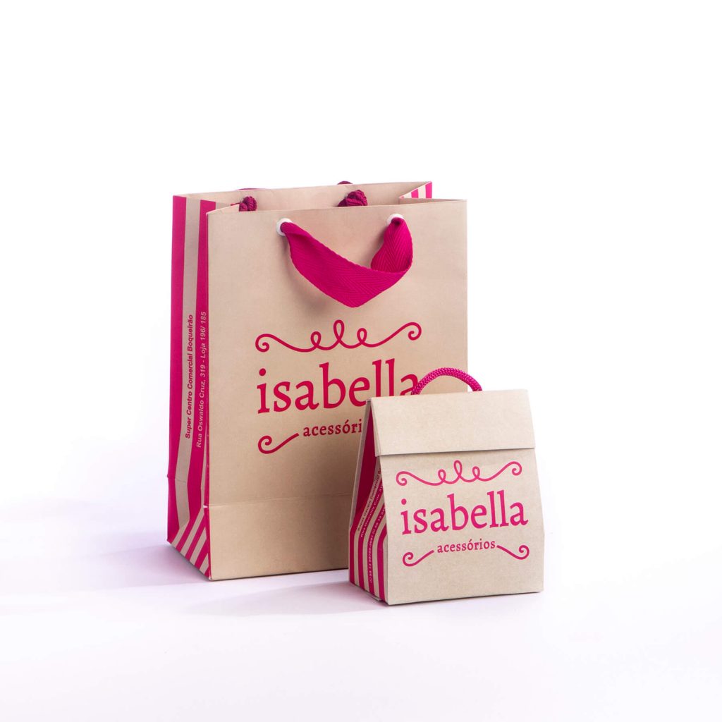 Two brown paper shopping bags with pink handles and pink text reading 'isabella acessórios'.