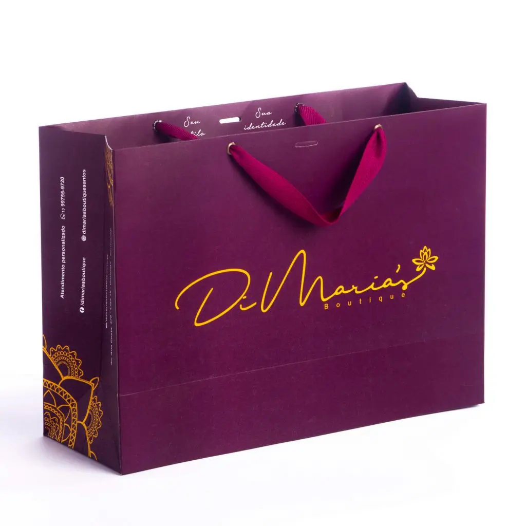 Purple shopping bag with burgundy handles and yellow cursive logo reading 'D. Maria's Boutique'.