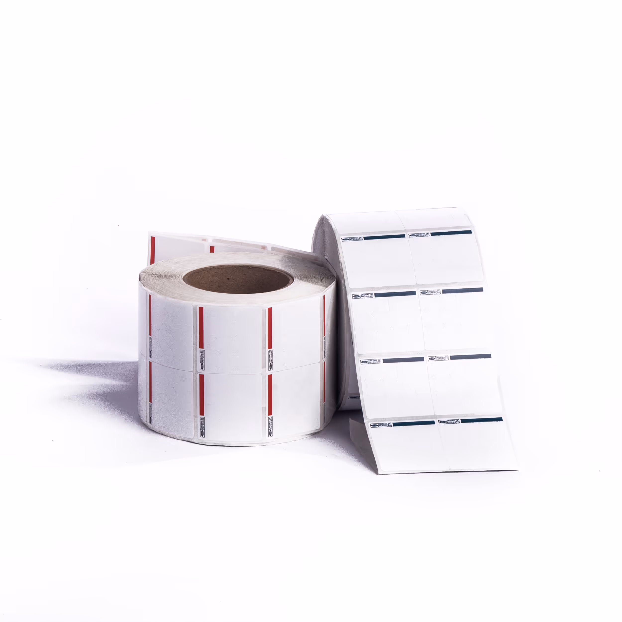 Two rolls of white adhesive labels with barcode and text, one standing upright and one partially unrolled.