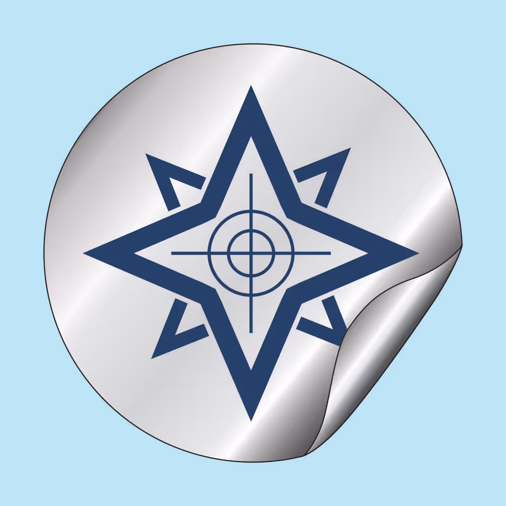 Round metallic sticker with a navy blue star-shaped compass and a crosshair design in the center, featuring a partially peeled corner.