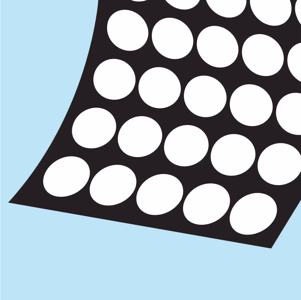 Close-up of a black surface featuring evenly spaced white circular holes against a light blue background.