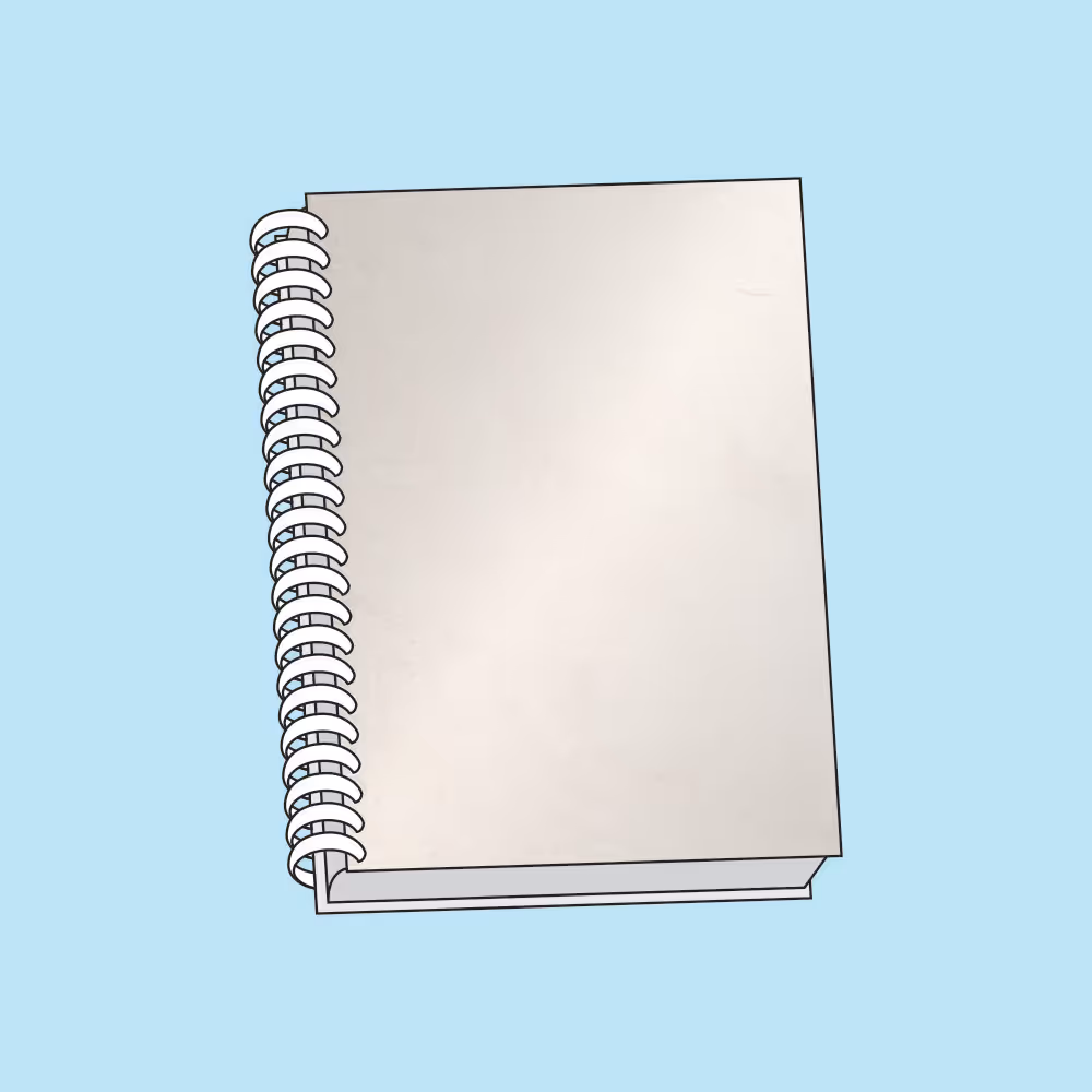 Closed spiral-bound notebook with a plain white cover on a light blue background.