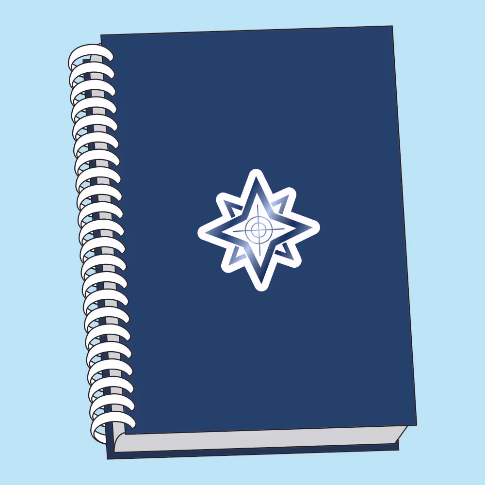 Closed navy blue spiral notebook with a white and blue star-like emblem on the cover.