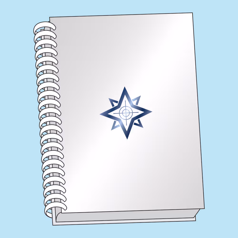White spiral-bound notebook with a blue star and crosshair design on the cover.