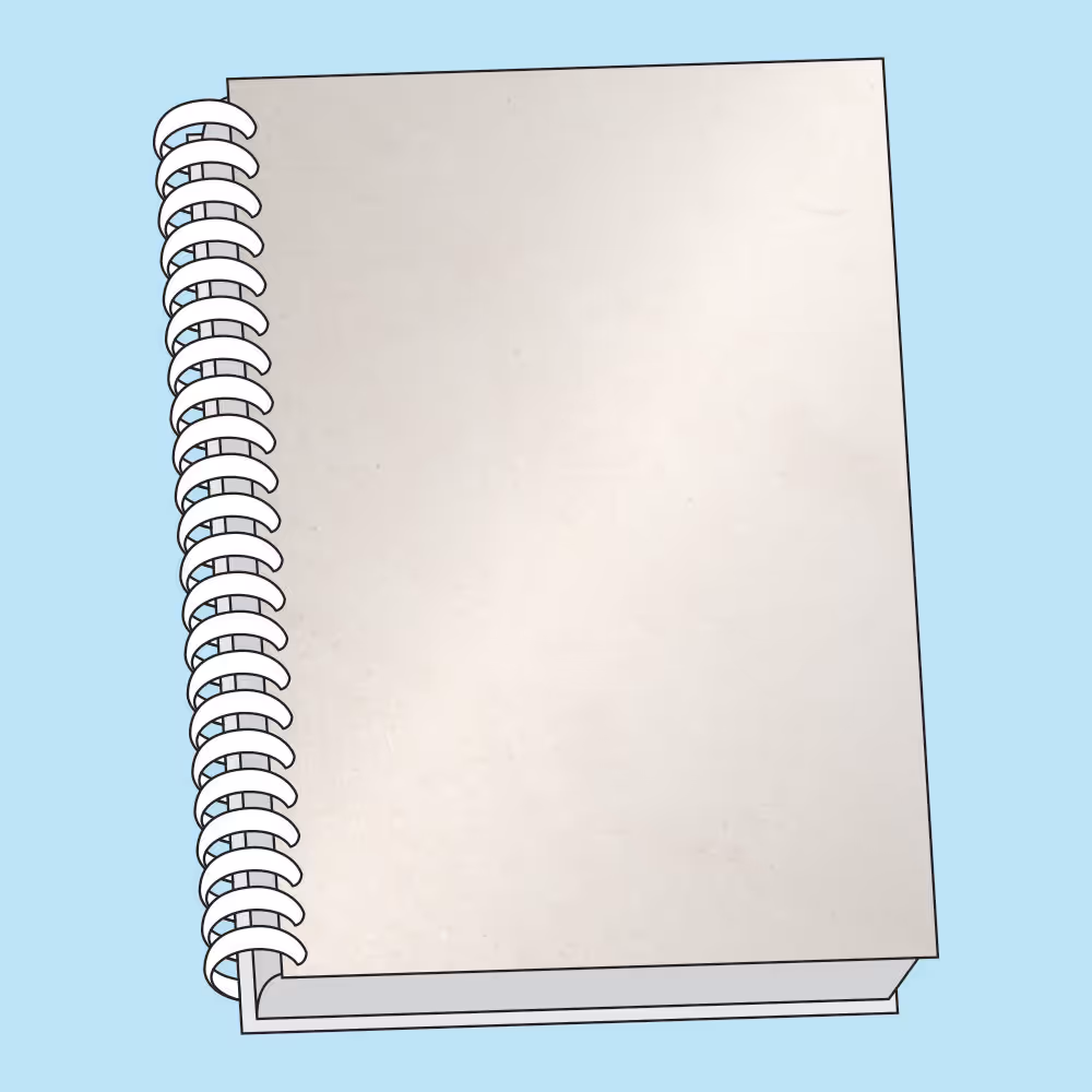 Closed spiral-bound notebook with a plain light gray cover on a blue background.