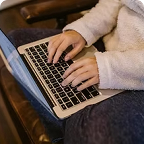 Person typing on a laptop, representing online learning.