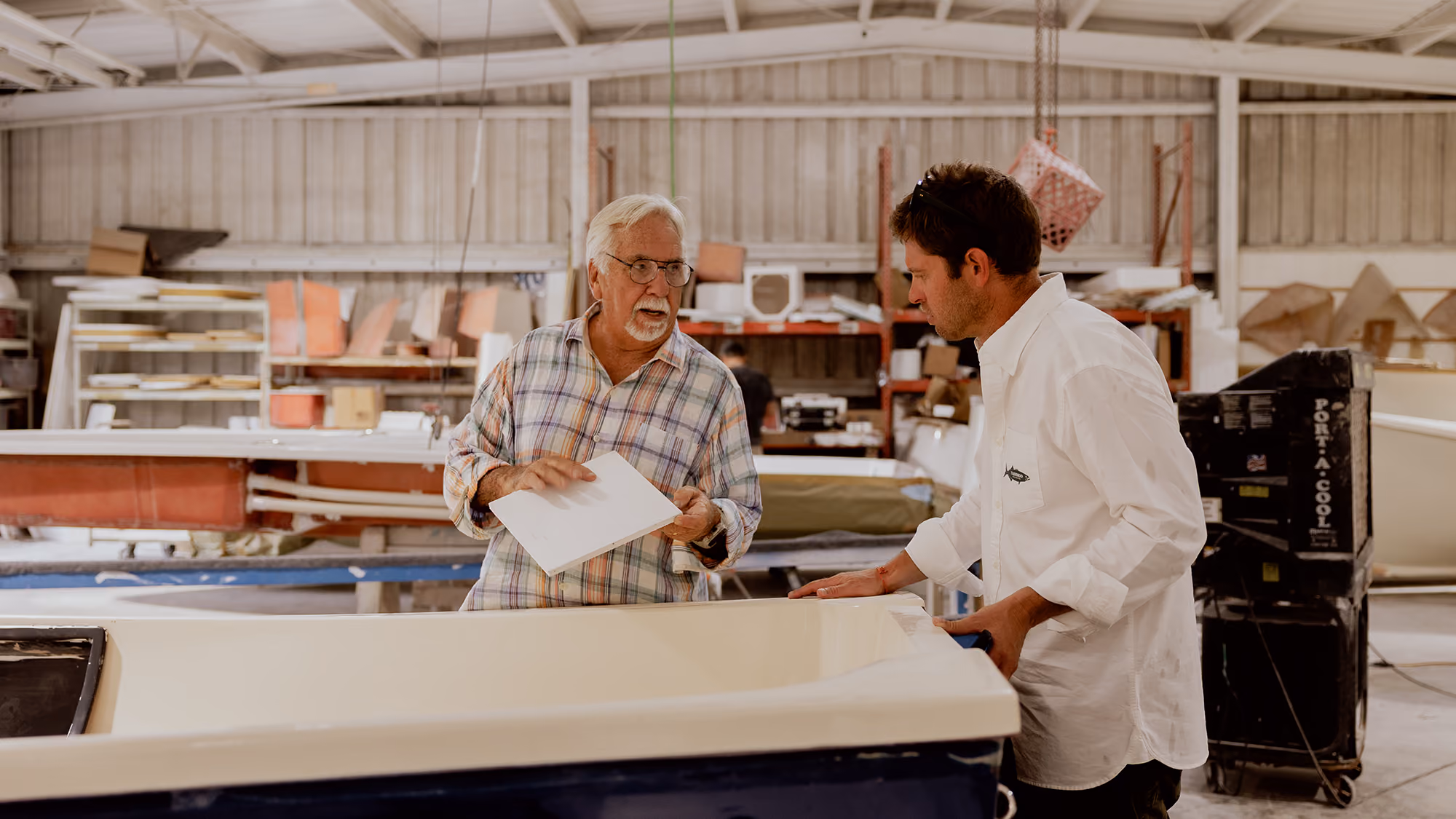 Man sitting in lab with fishing memorabilia 