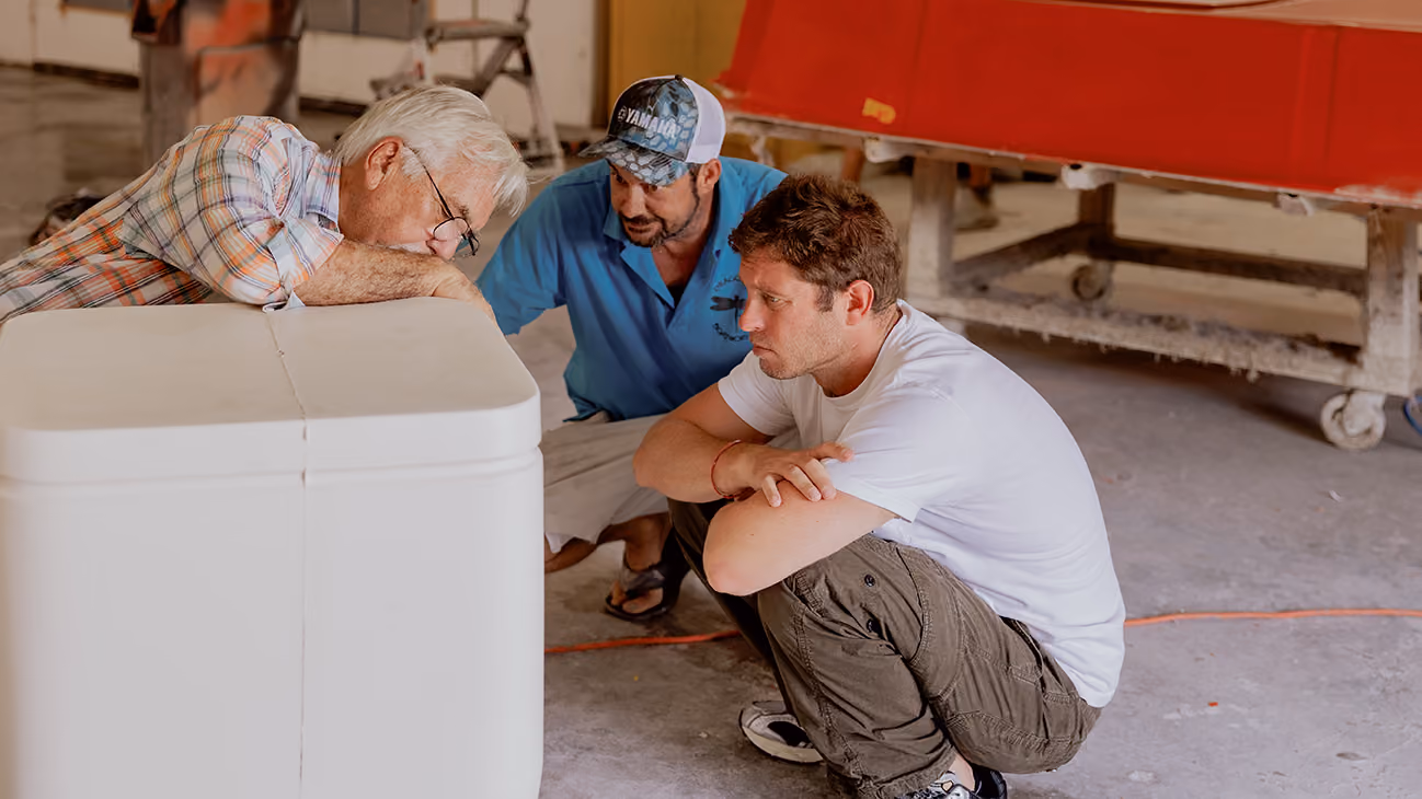 luxury fishing boat builders looking at the mold of a custom skiff
