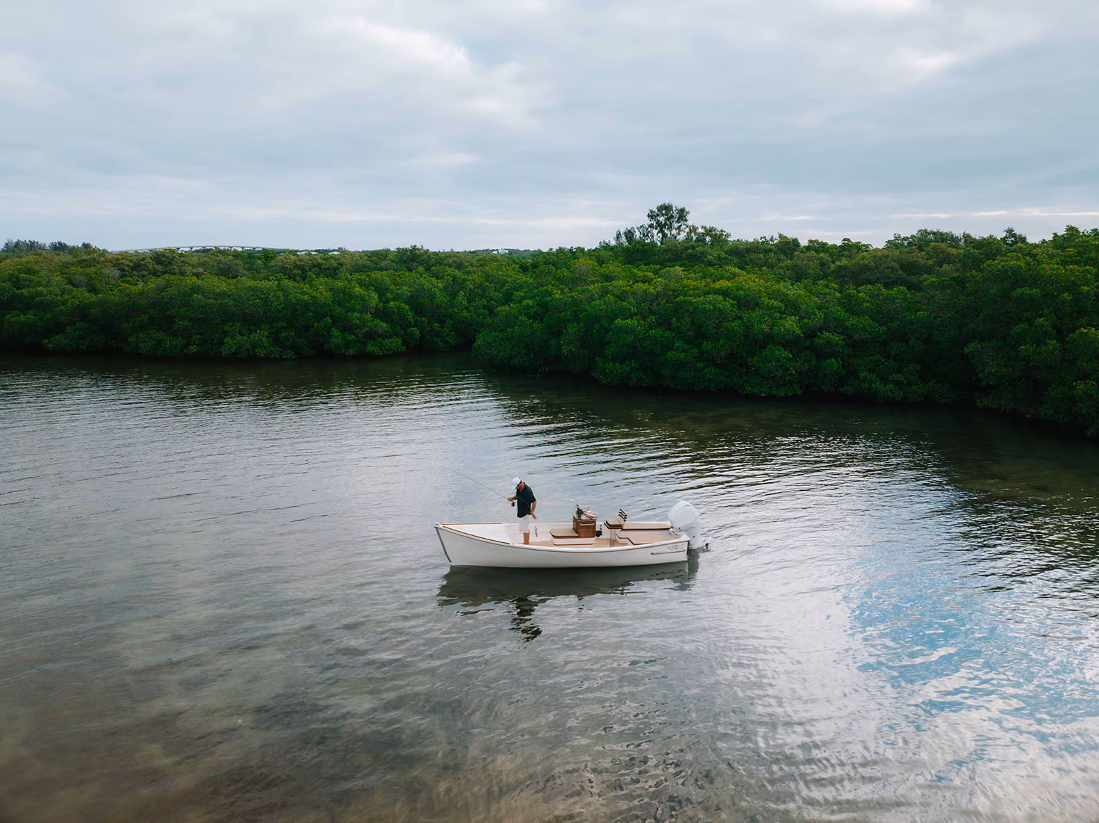 boater fishing on custom skiff
