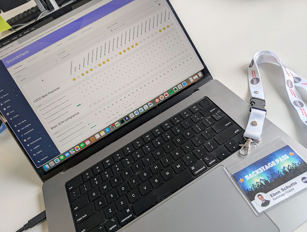 Backstage Pass and lanyard next to a laptop displaying Spotify’s Soundcheck plugin for Backstage