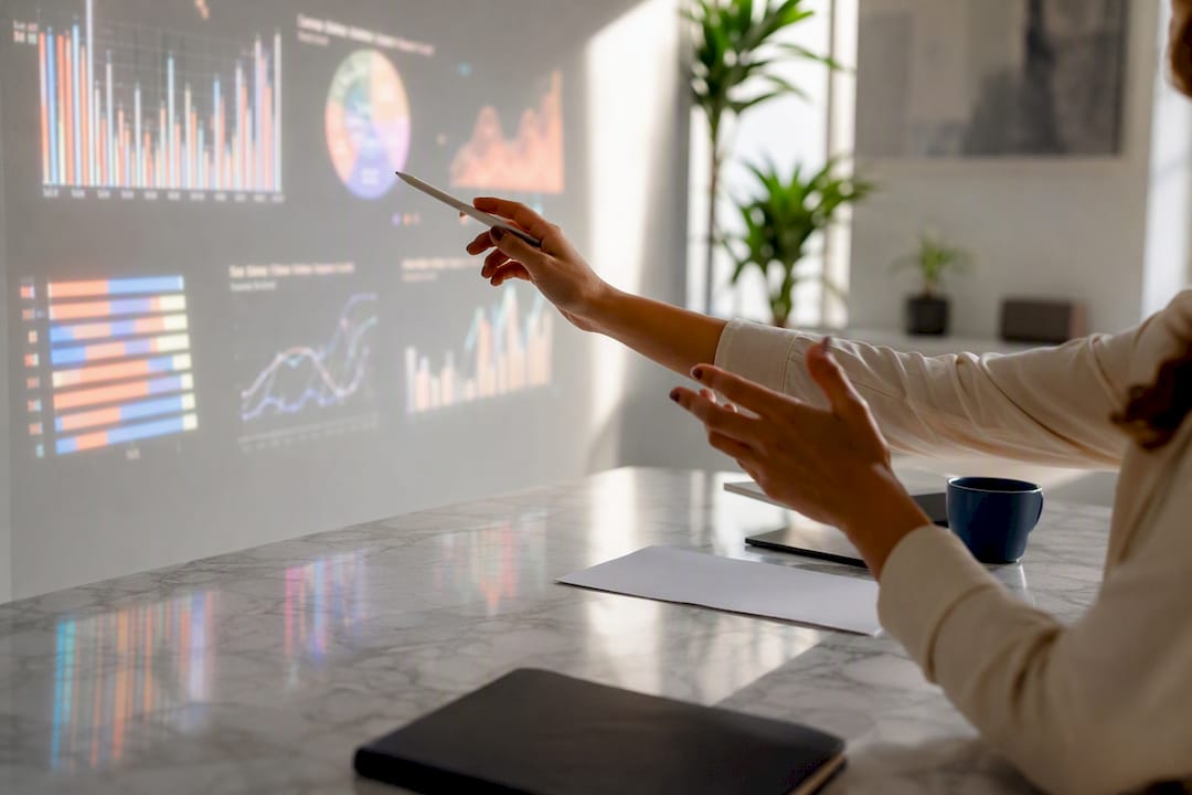 Hands interacting with analytics data projection