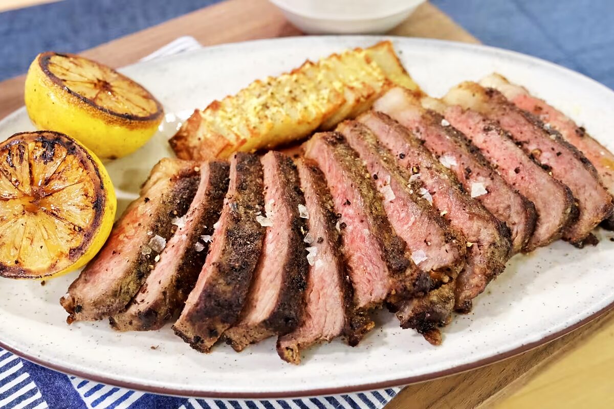 Pan-seared New York strip steak on a white plate from Chef Tim Love's TODAY Show appearance