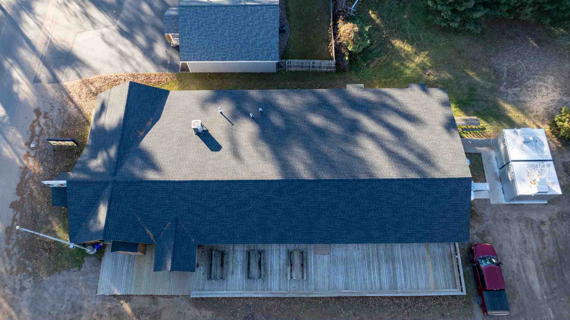 A complex Northwoods roofline with multiple gables and dormers - asphalt shingle roof replacement cost wisconsin