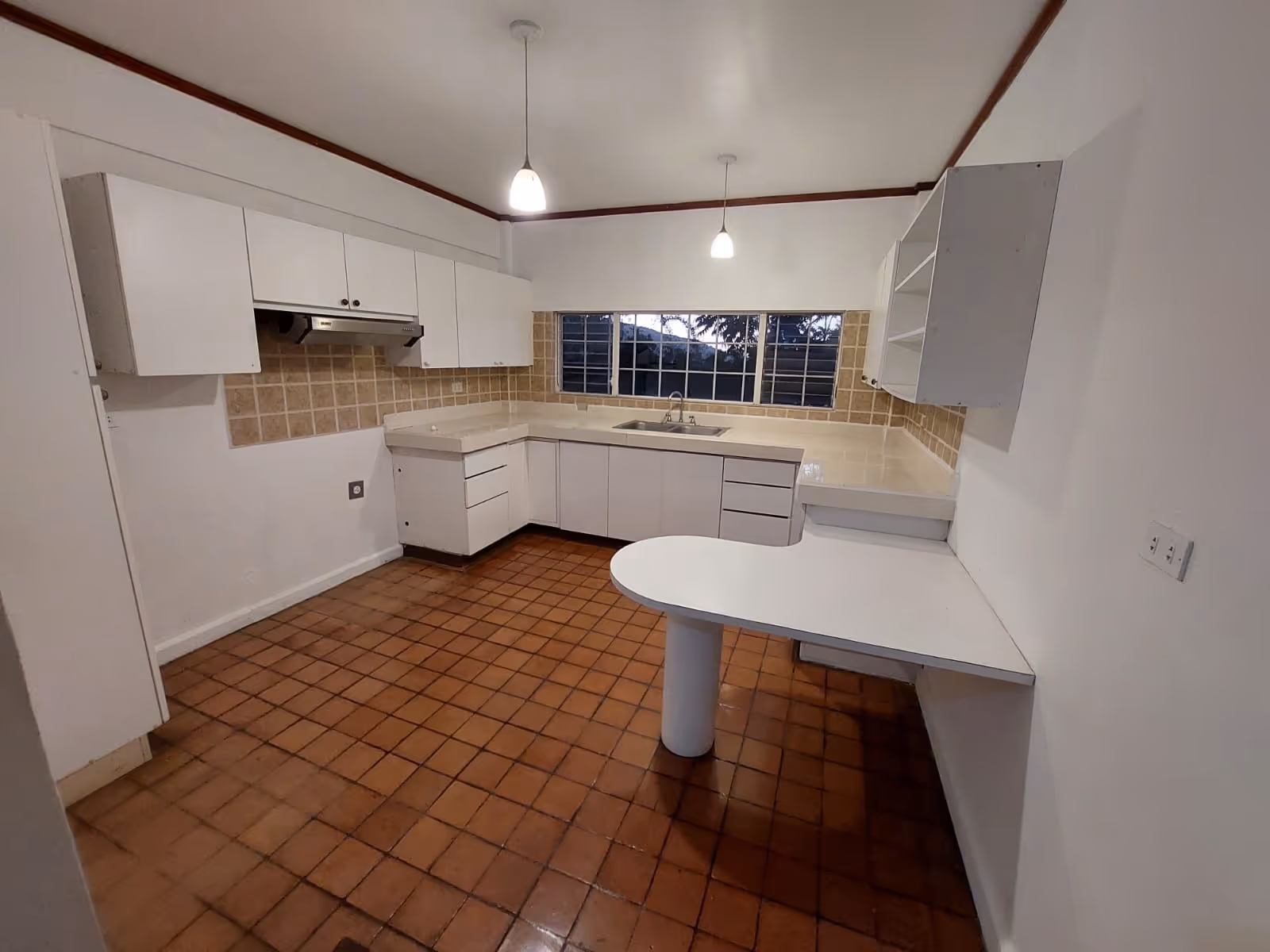 Bright and functional, the vintage-style kitchen opens to lush garden views, ideal for a thoughtful redesign that blends charm and utility.