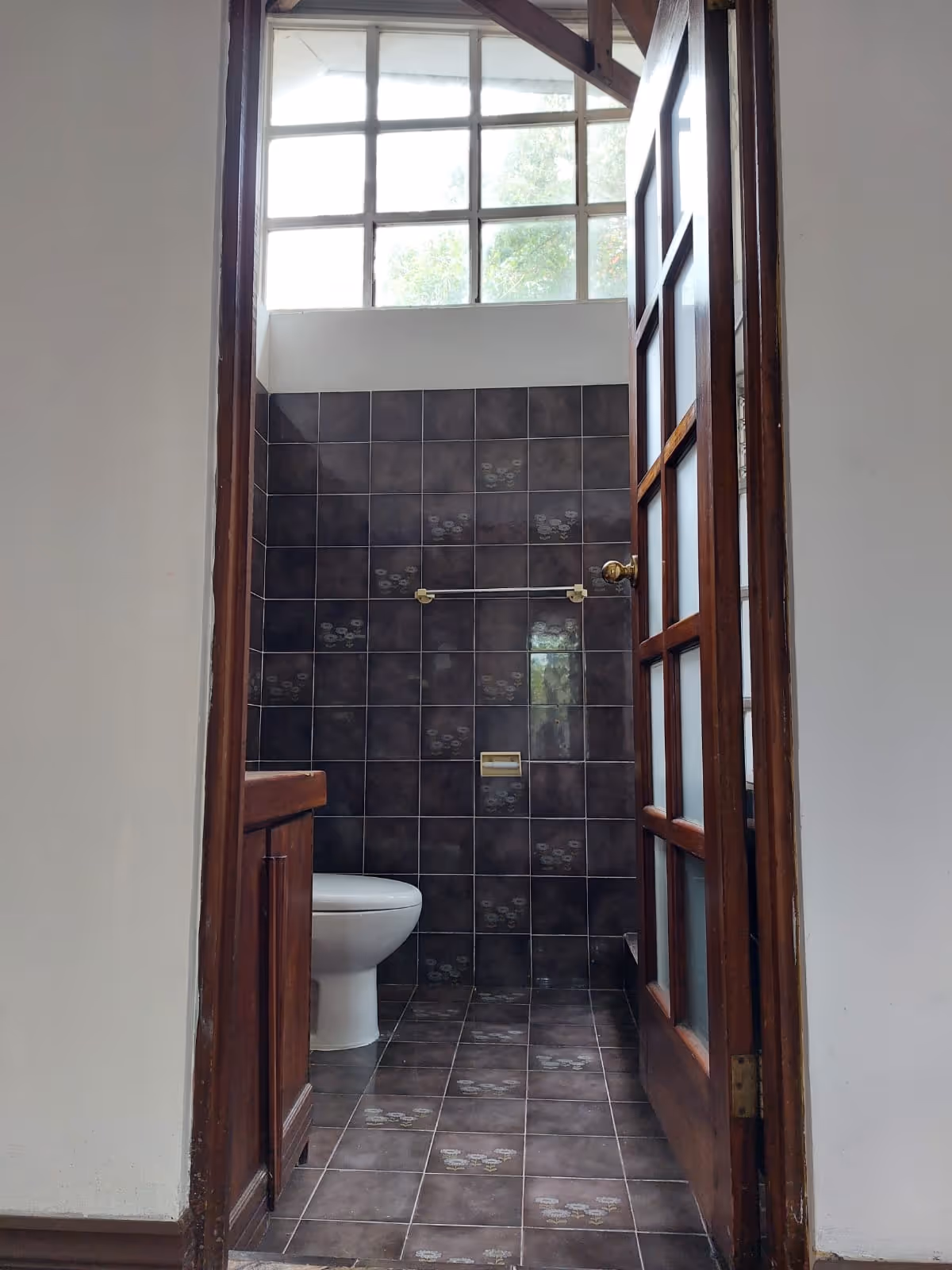 A unique airy layout featuring French-pane windows and high ceilings, perfect for a spa-inspired redesign.