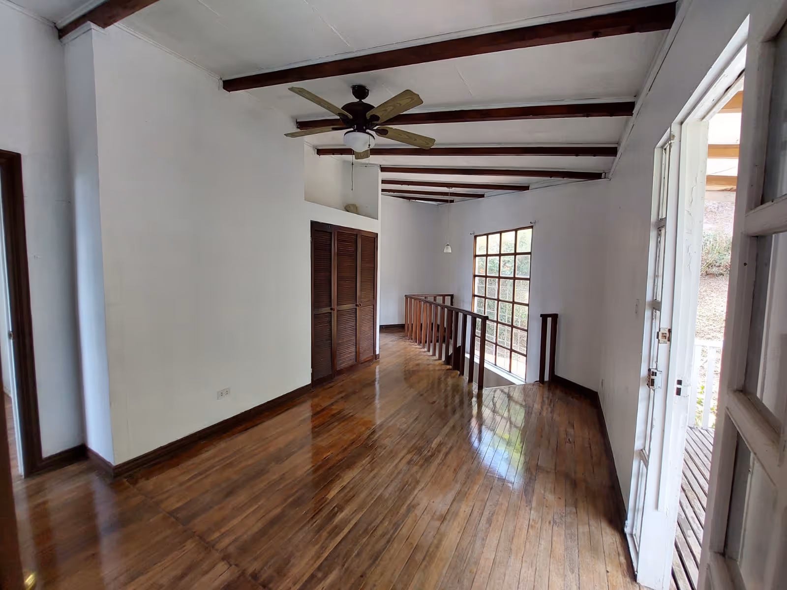 A quaint, light-filled space connecting the upper bedrooms — perfect as a reading nook or TV area.