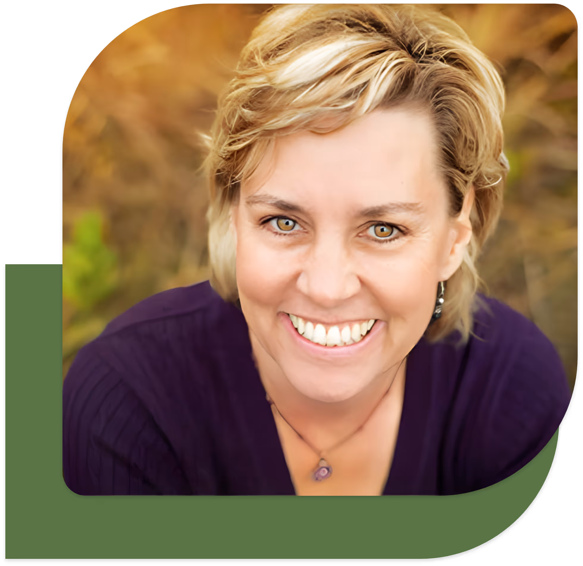 Close-up of Kimberly Potter with short blond hair wearing a purple top and a pendant necklace.
