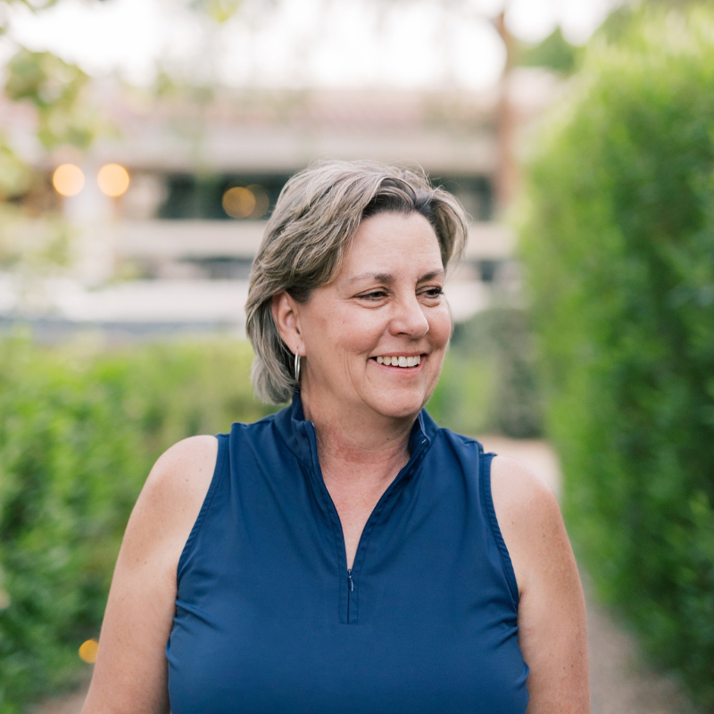 Picture of Kimberly Potter smiling and looking to the right with a greenery background outside