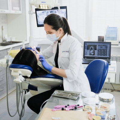 Female dentist doing emergency orthodontics on a patient