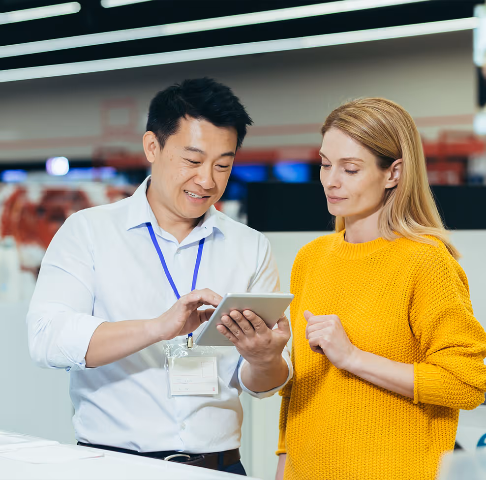 In-person sales associate at a retail store, smiling with an ipad.