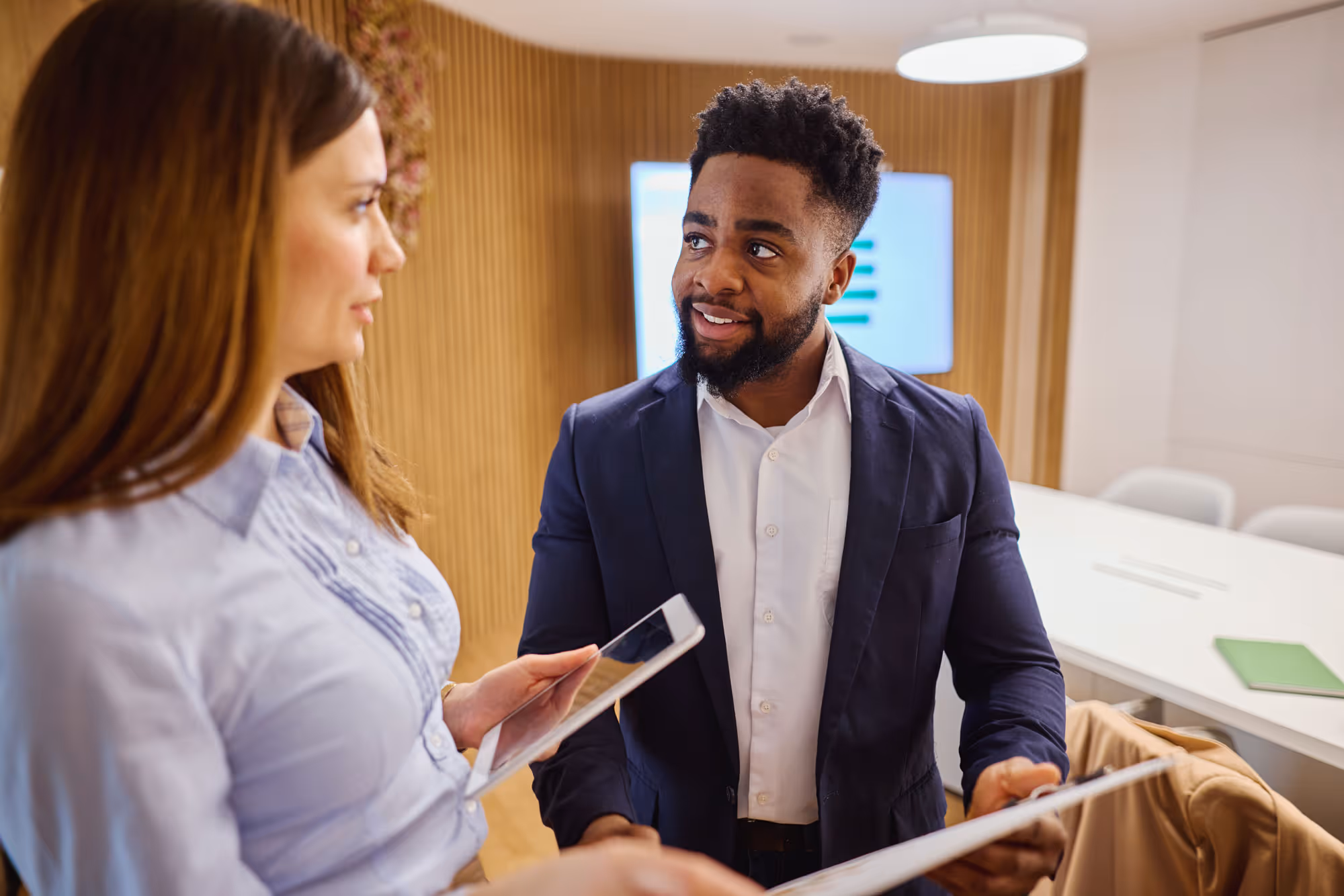 B2B brand ambassador meeting with a small business owner in a meeting room to discuss product or service.