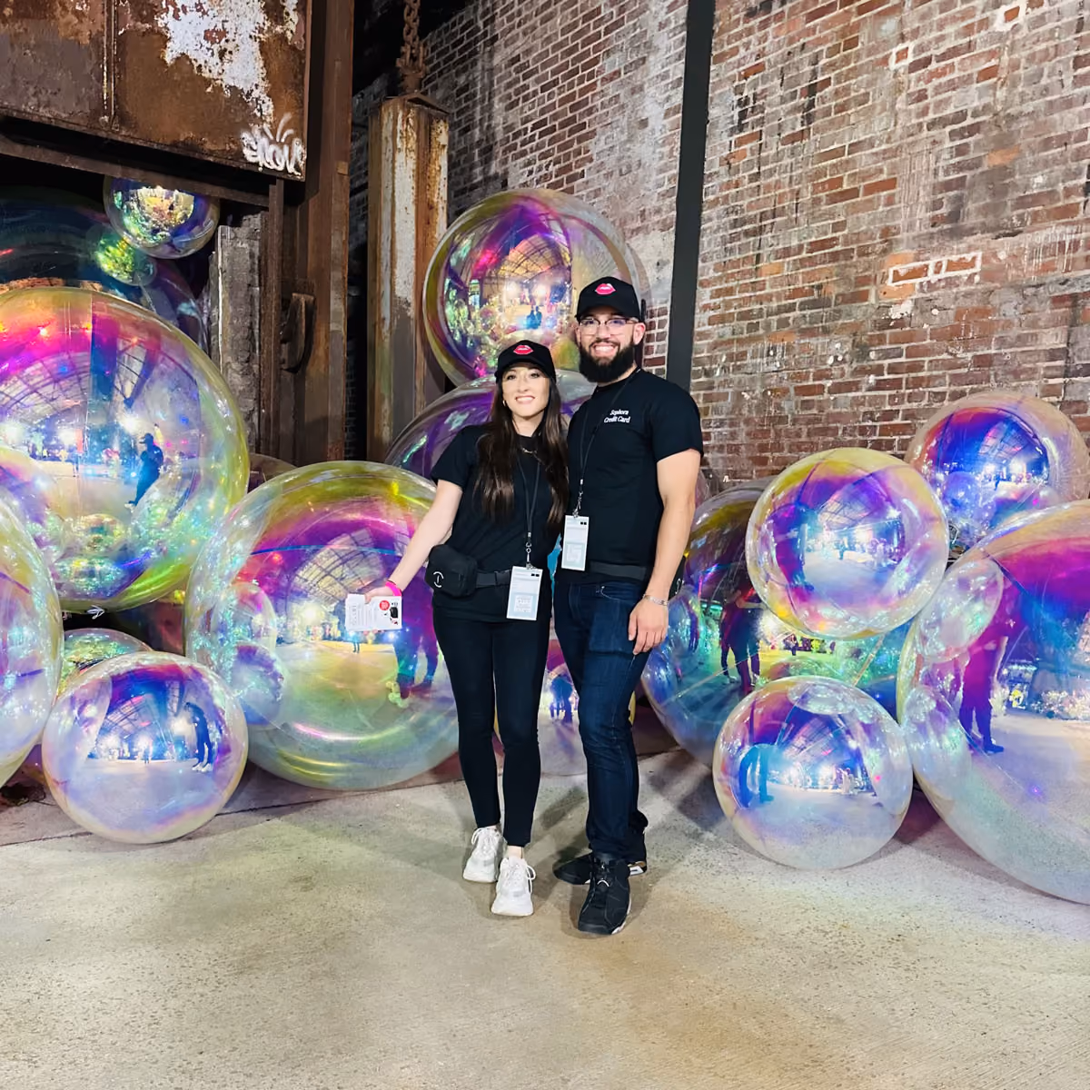 Experiential marketing and event workers standing in front of a bubble-shaped installation in a warehouse event space.