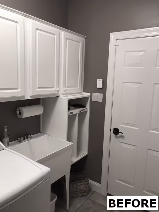 View of laundry room floor with scattered items and furniture.