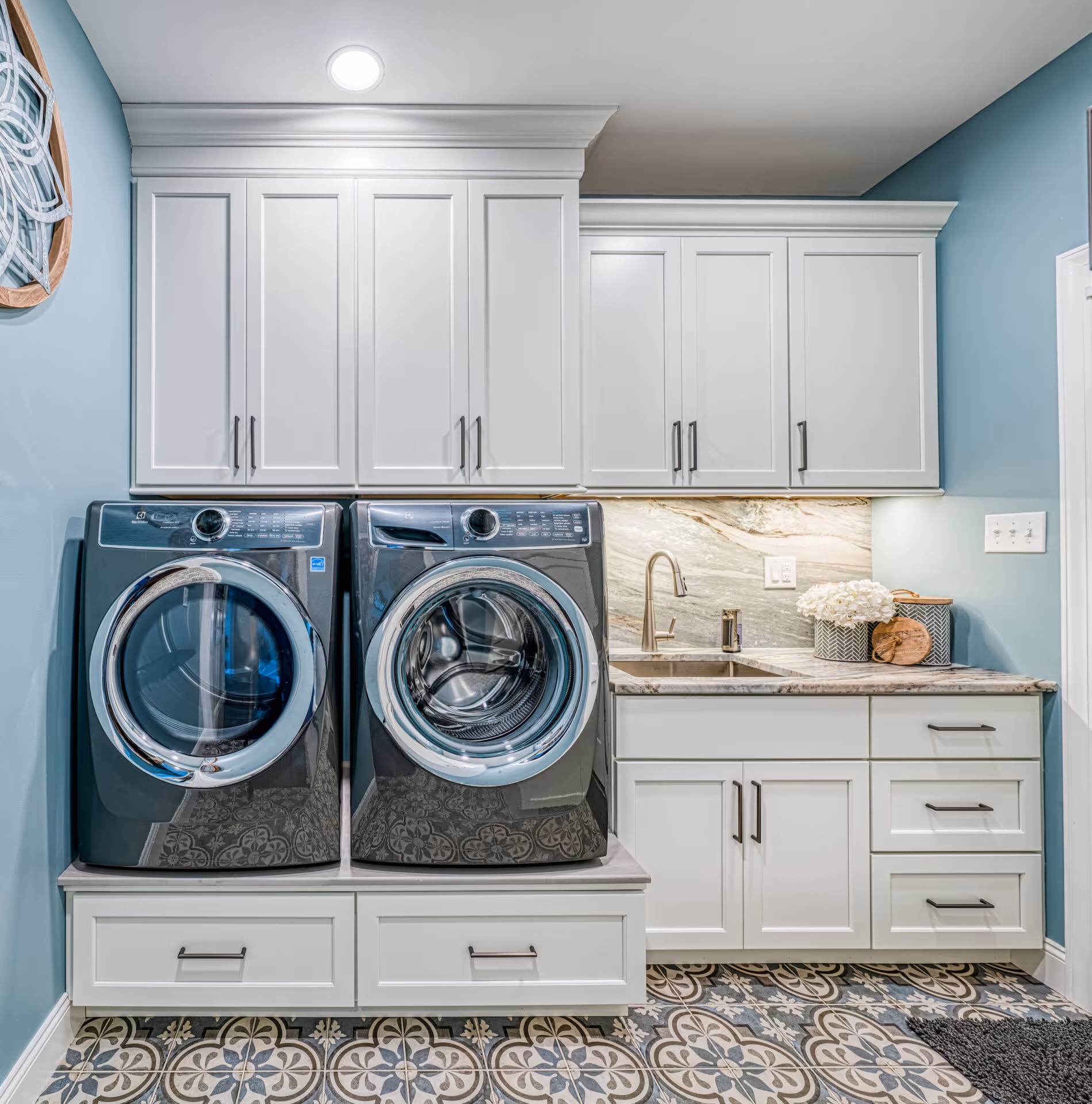 After: Functional laundry area with washer, dryer, and ample storage.