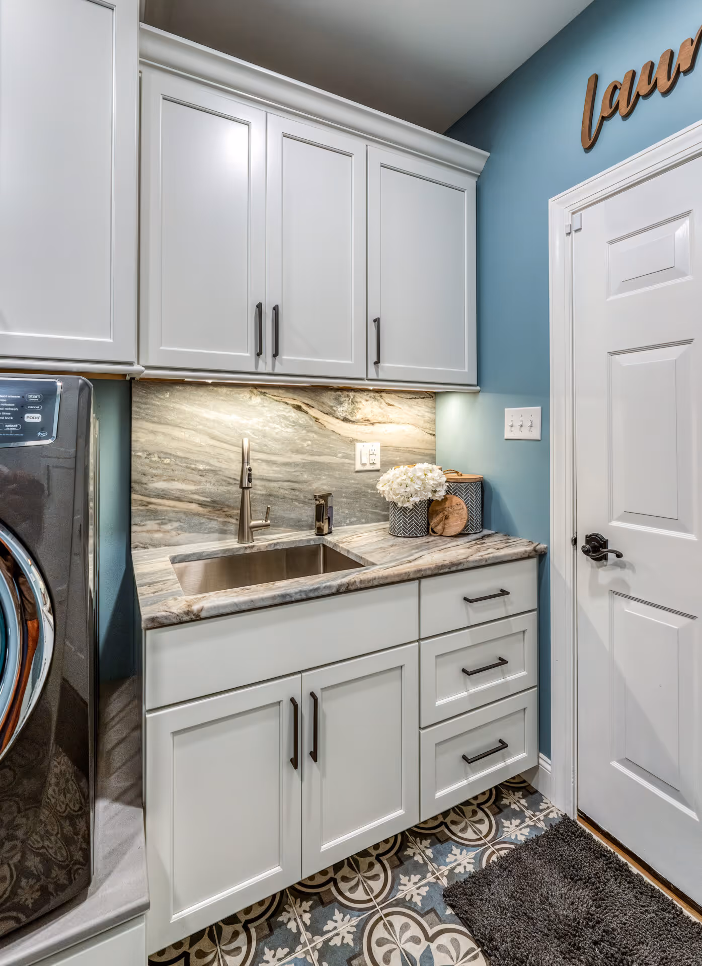 After: Laundry room with a functional sink and organized space
