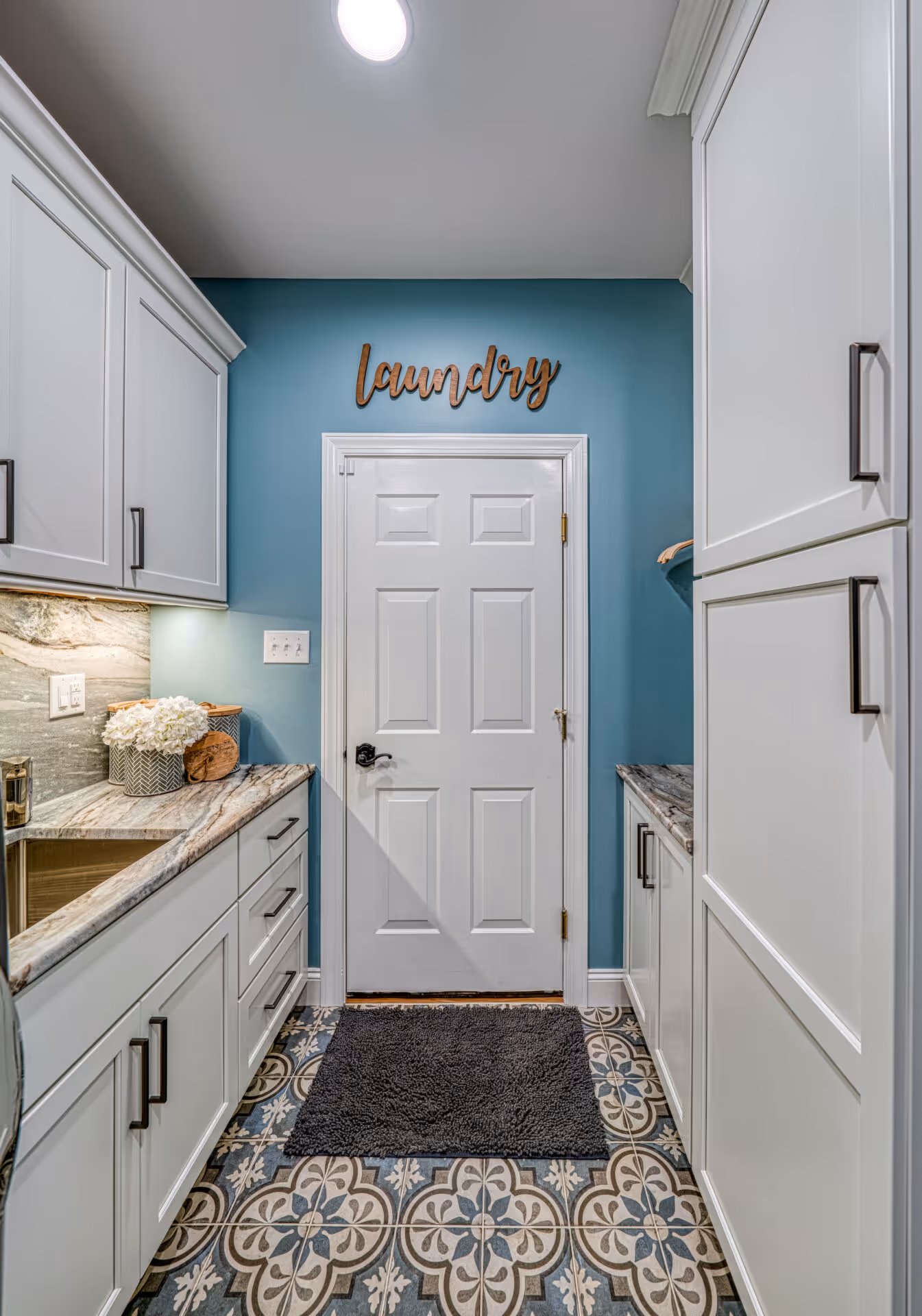 After: Neat laundry room with spacious storage and counters