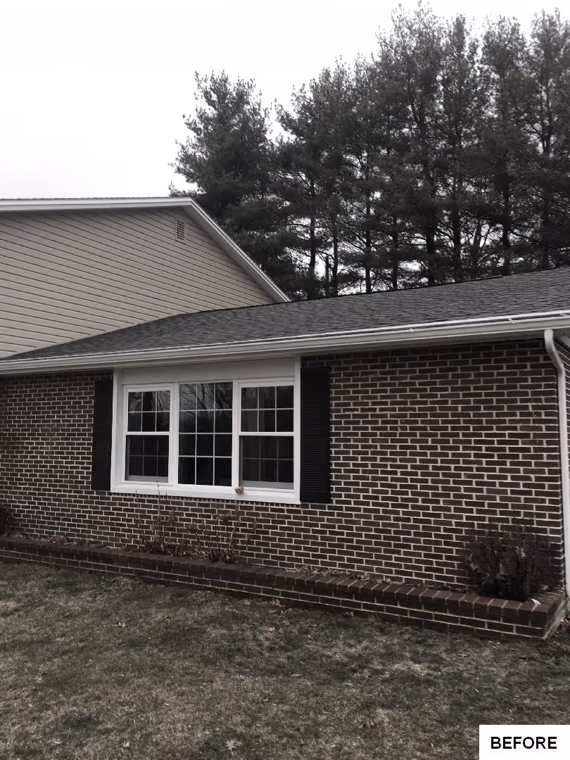 Before: Exterior view of the house with a cloudy sky and trees
