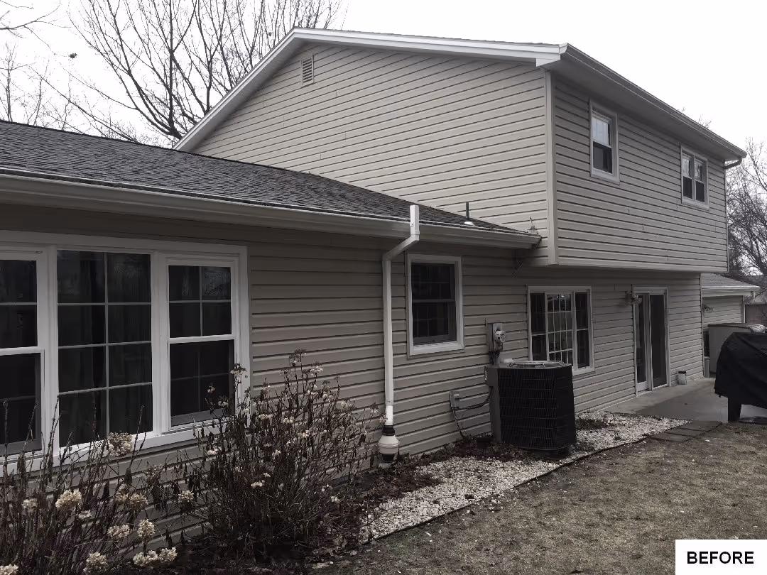 Before: Side view of the house showing windows and backyard area.