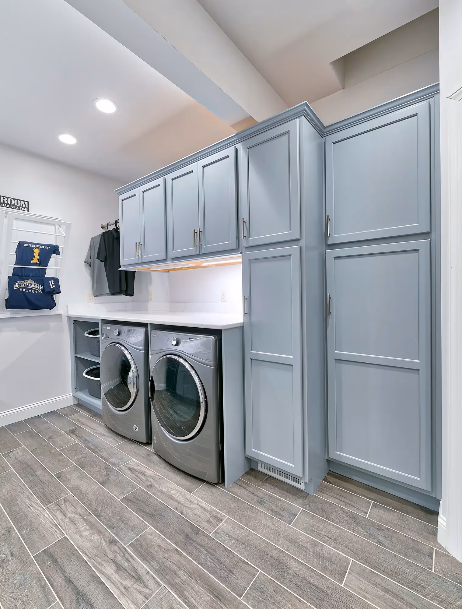 Contemporary laundry room featuring gray cabinetry and modern appliances in mechanicsburg, pa.