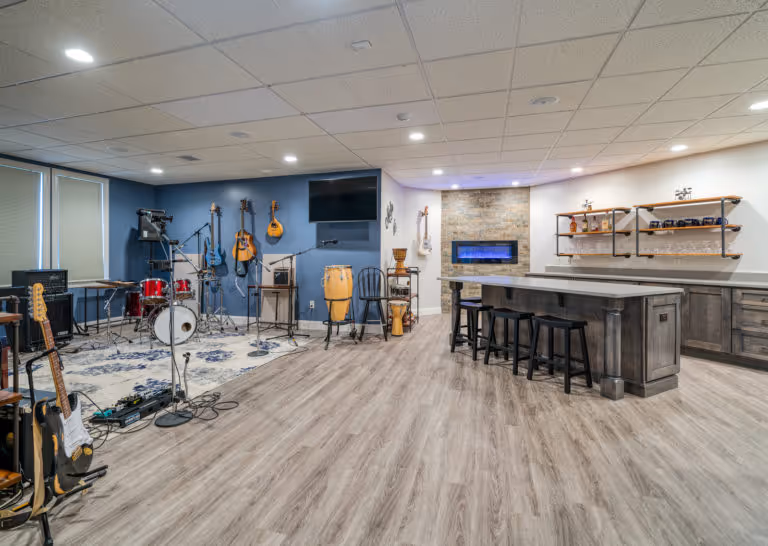 Modern basement entertainment area in Mechanicsburg, PA, featuring musical instruments, a bar area, and contemporary decor.
