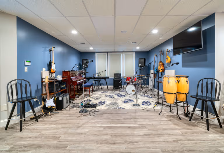 Modern music area in Mechanicsburg, PA featuring instruments, seating, and acoustic design elements.